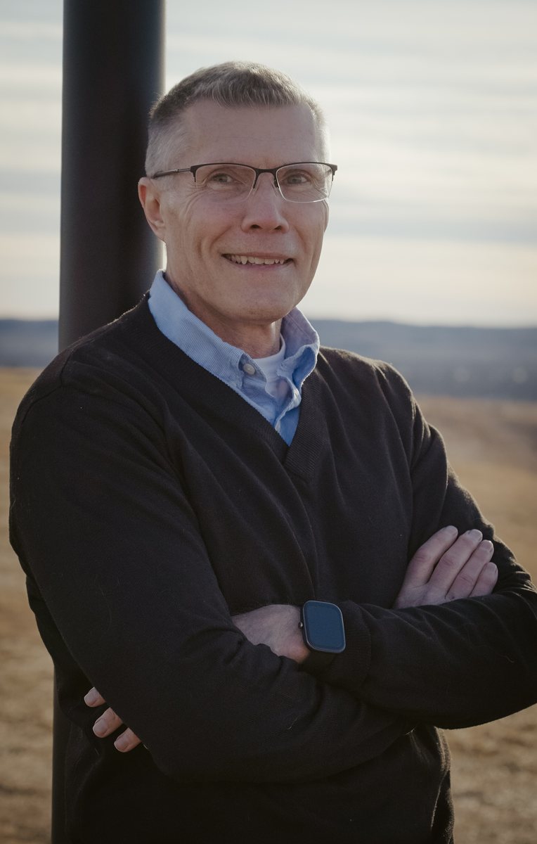 Rick Boehm standing outdoors in a professional portrait